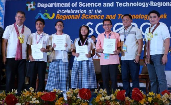 Posing with pride - Santiago City National High School quizzers receive certificate, medal and cash prize with DOST Sec. De La Peña (L) and their coach, Norman Sanchez (2R) and Superintendent, Florante Vergara (R)