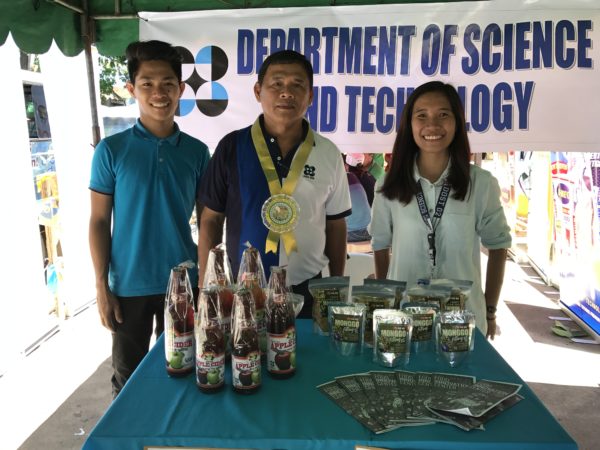 (L-R) Patrick Cristobal, Engr. Marcelo G. Miguel, and Charmaine Tagarino posts in the booth of DOST R02 with apple and munggo-based products